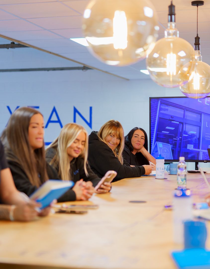 women sat around a table smiling and laughing