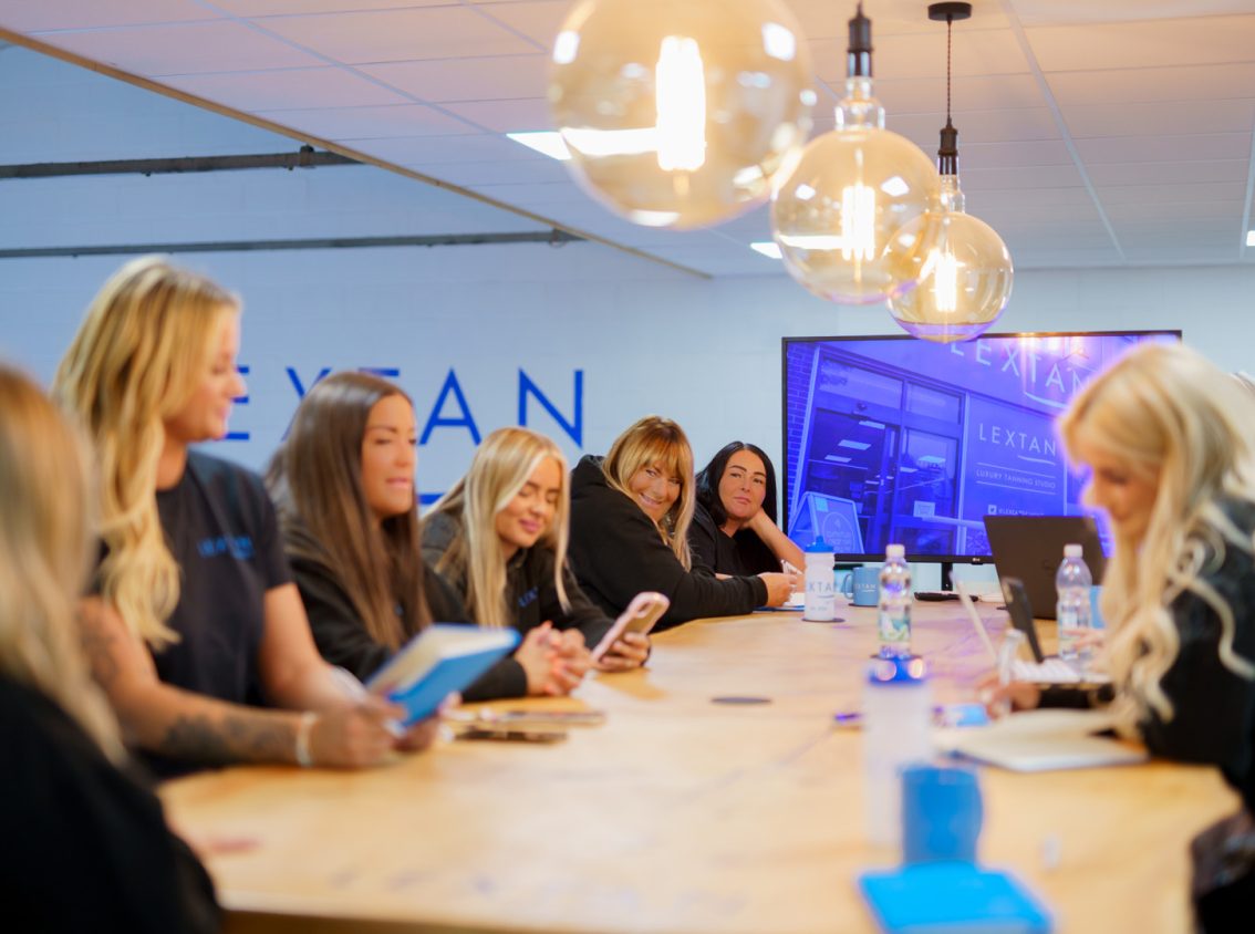 women sat around a table smiling and laughing