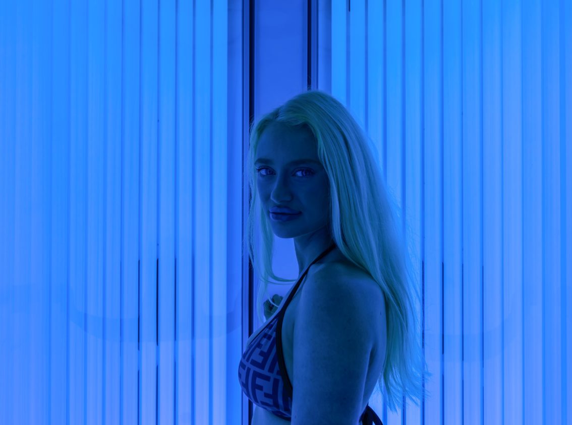 blonde woman in bikini in blue light