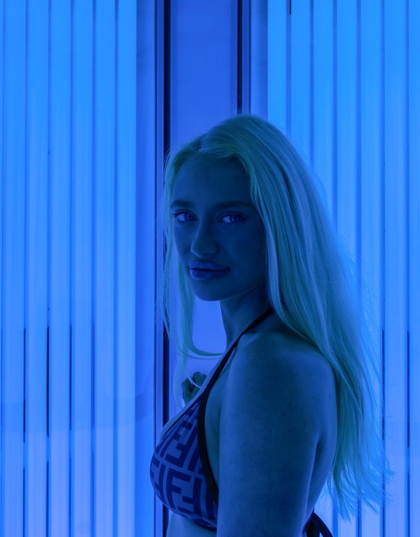 blonde woman in bikini in blue light