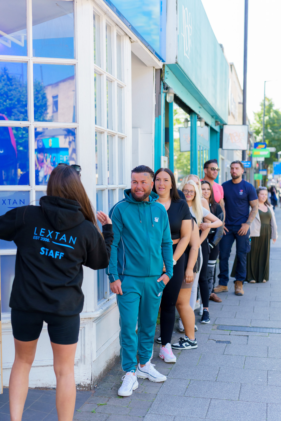 people queueing outside a Lextan store waiting to enter